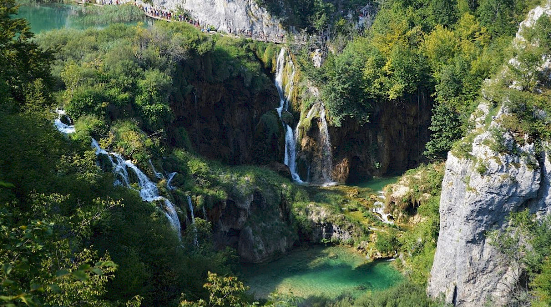 Plitviče Lakes National Park is a chain of 16 terraced lakes joined by waterfalls that extend into a limestone canyon.